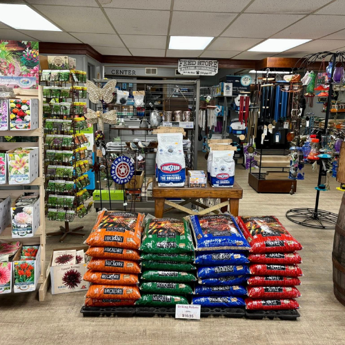Garden store interior with vibrant displays of seeds, gardening supplies, and colorful stacks of Hickory wood chips. Cozy and inviting atmosphere.