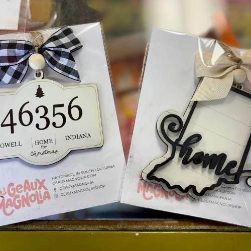 Two decorative ornaments displayed in packaging. One features 