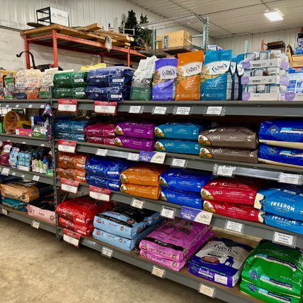 Pet Food & SuppliesShelves filled with colorful bags of pet food are displayed in a well-lit store. Various brands and sizes are organized neatly, conveying abundance.
