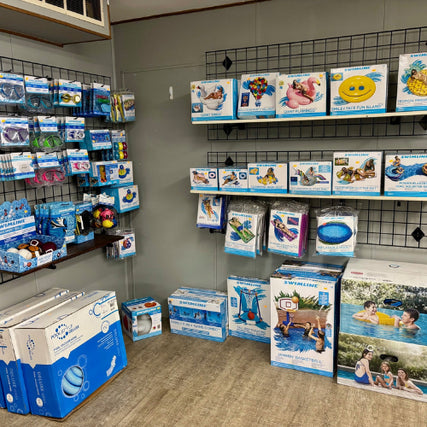 Pool Chemicals & SuppliesStore display of colorful pool accessories, including inflatables, goggles, and toys, neatly arranged on shelves, conveying a fun and summery vibe.