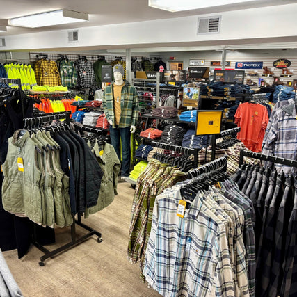 Clothing & BootsClothing store interior featuring racks of plaid shirts, vests, and mannequins. Bright colors and casual wear dominate, creating a vibrant, welcoming atmosphere.
